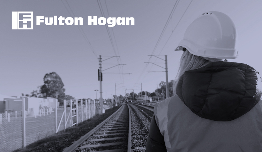 Fulton Hogan Hero Image woman in hard hat looking at train tracks