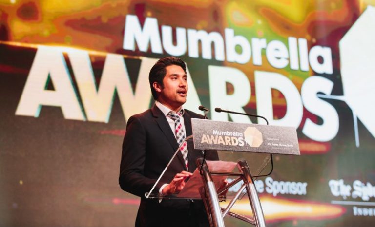 Photo of Damian Francis standing on stage at the Mumbrella Awards